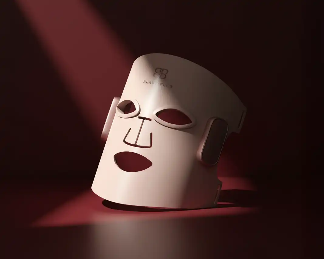 White LED mask with brand logo on a dark background