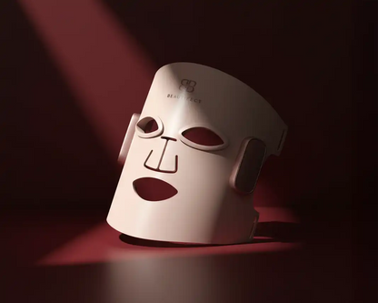 White LED mask with brand logo on a dark background