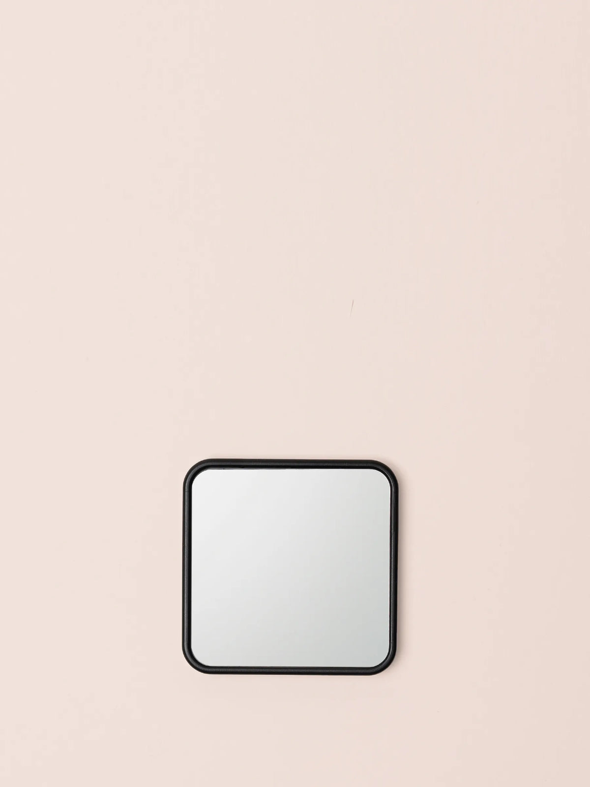 5x Magnification Mirror Black, front view on a pink background